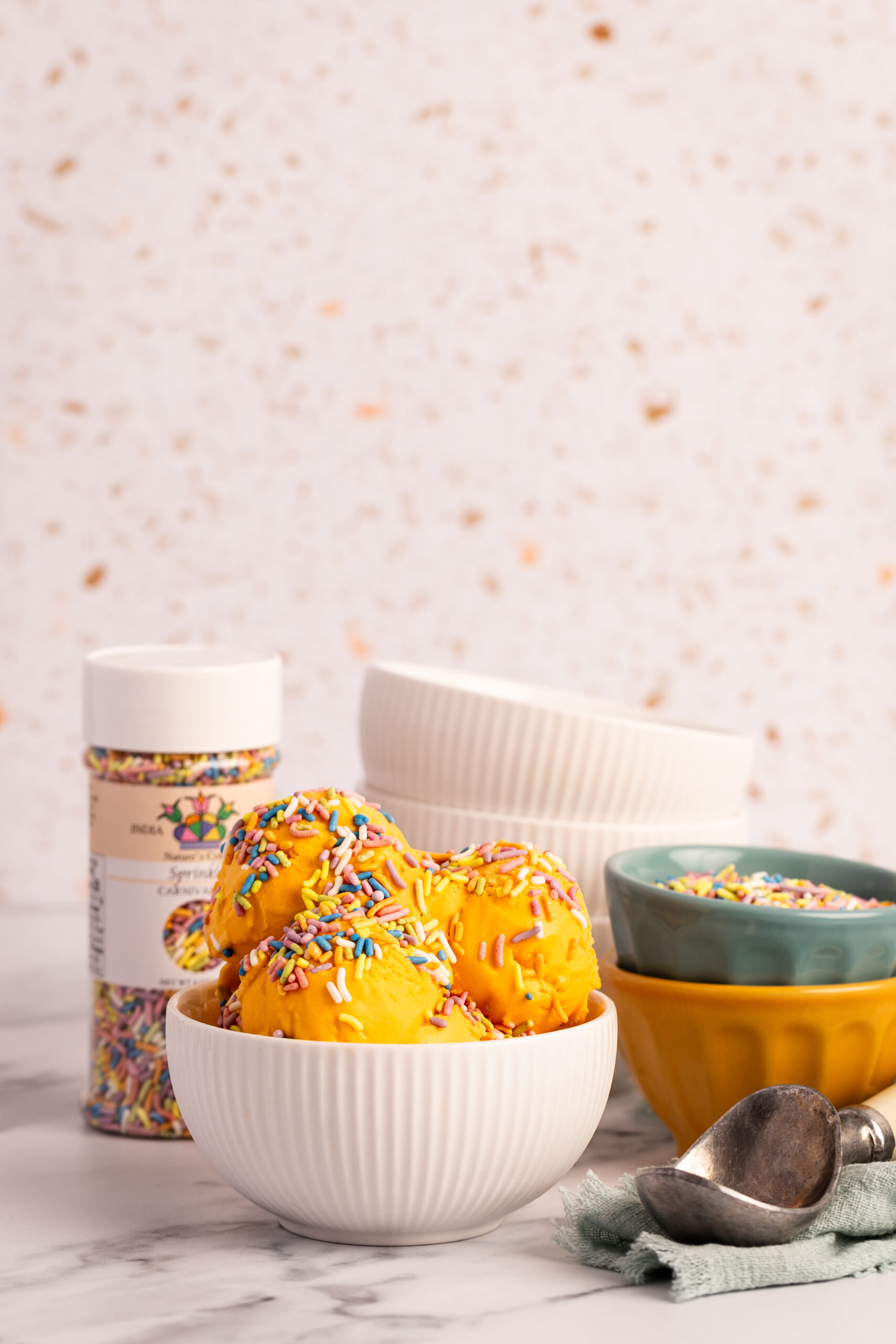 Assorted natural sprinkles in jars and bulk pails