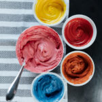 Bowls of vibrantly colored frosting, achieved with the India Tree Nature's Colors Decorating Set (natural food coloring).