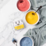 The India Tree Nature's Colors Decorating Set displayed beside bowls of vibrantly colored natural frosting, ready for decorating.